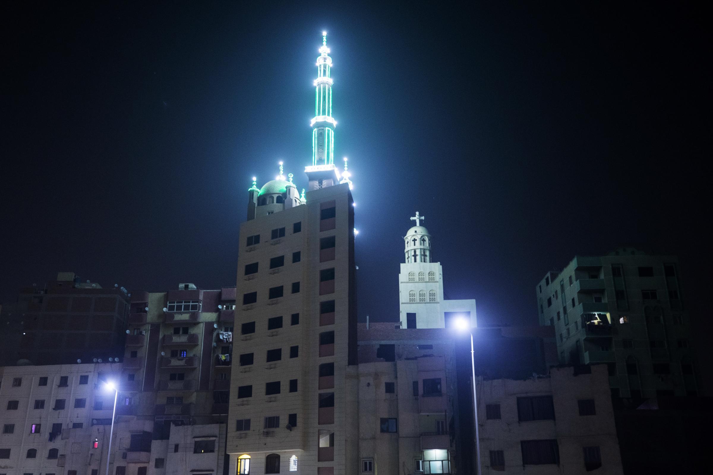  A Coptic church and the minaret of mosque on top of a residential building in Cairo. 