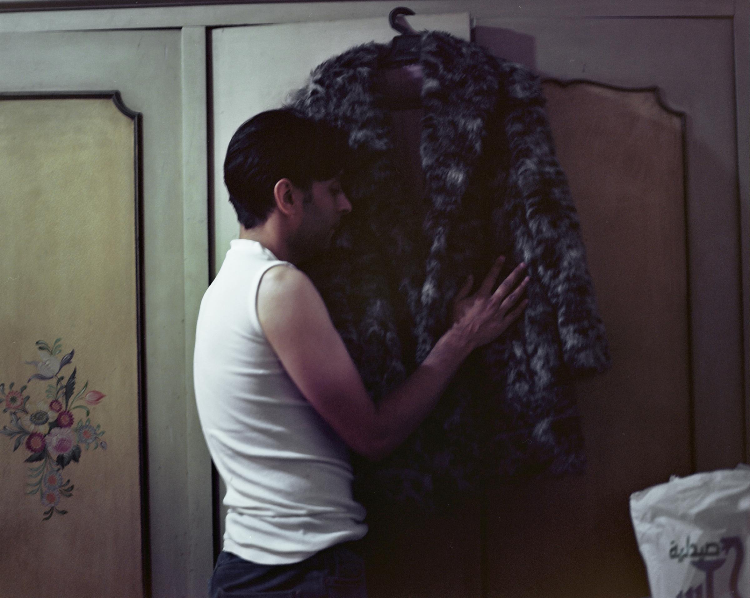  40-year-old Ahmed El-Benawy, touches the fur coat of mother in his parents bedroom at his apartment, in Cairo, Egypt. &quot;My mother is the one who helped me understand everything surrounding HIV after I found out I was positive,&quot; said Ahmed, who is among thousands of Egyptians living with HIV. She passed away, and now he wants to leave Egypt. He can no longer stand the social stigma around HIV and AIDS. 