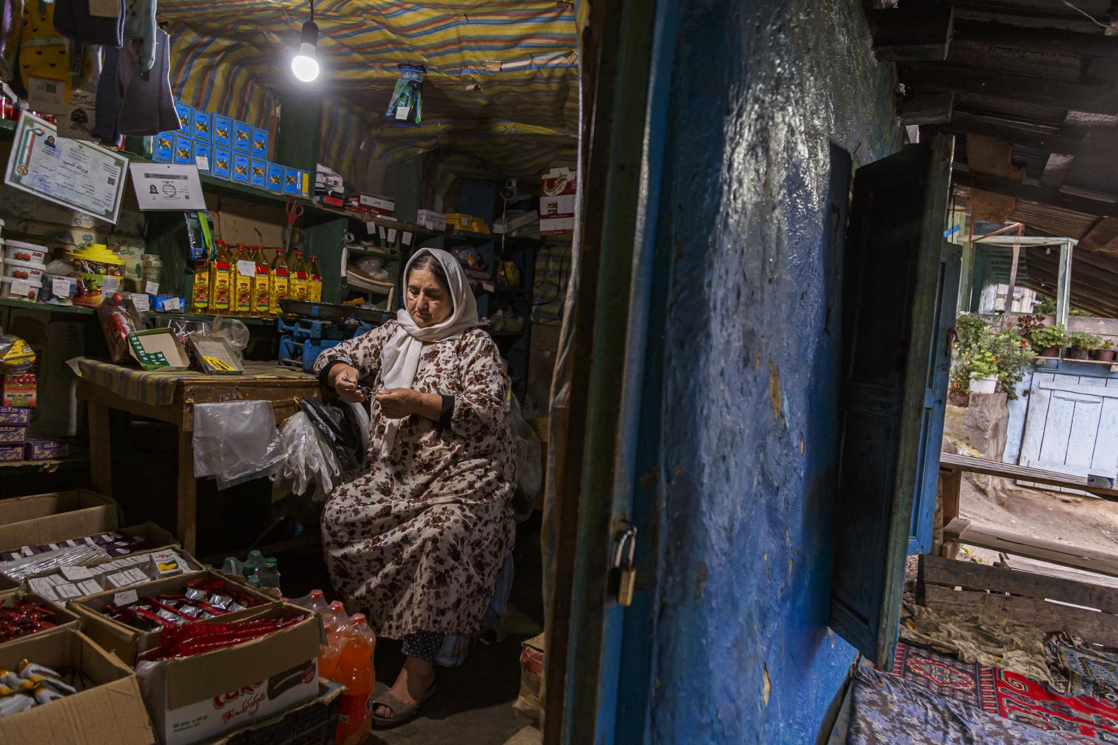  The Rouhangiz grandmother&#39;s shop, she is doing calculations first thing in the morning. 