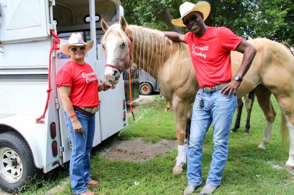 Chicago's Black Cowboys - Greg and his wife Desi pose with their horse Dallas before prepping him and saddling up for the...
