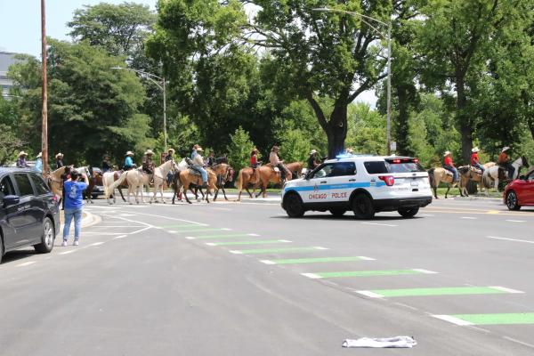 Chicago's Black Cowboys - Chicago police block traffic to allow safe passage of the riders through Washington Park during...