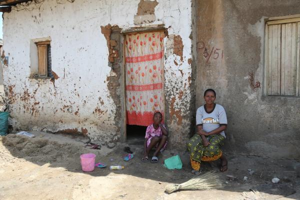 Bujumbura - City in the Heart of Africa - A woman and her child sit outside of their house in the Kamenge neighborhood. People living in...