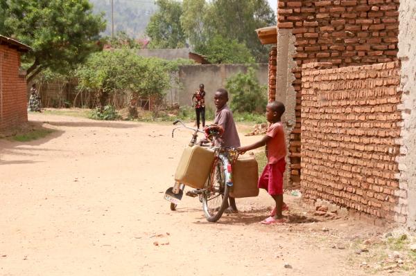 Bujumbura - City in the Heart of Africa - A boy on a bicycle has containers to fetch water with; Burundi is one of the few countries where...