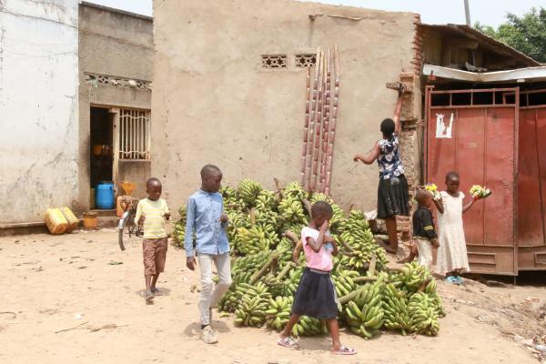 Bujumbura - City in the Heart of Africa - Children walk by bananas intended for sale. Burundi has one of the world