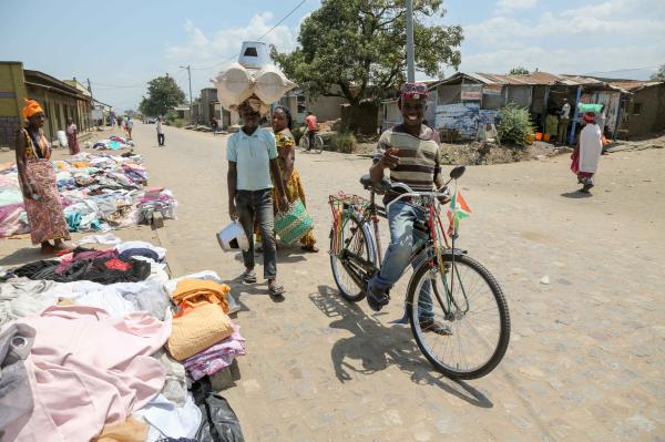Bujumbura - City in the Heart of Africa - A woman sells second hand clothing on the sidewalk in the Kamenge neighborhood. Women are often...