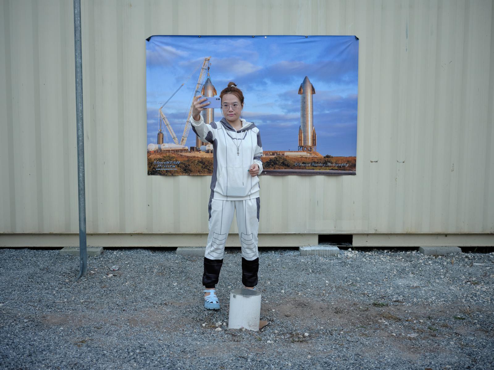 A woman dressed in an astronaut...ter featuring SpaceX starships.