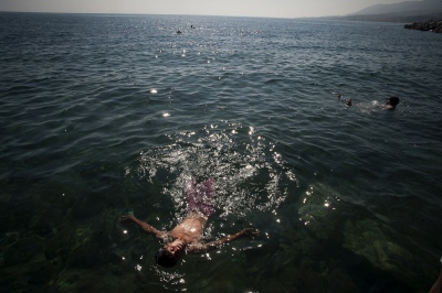   With temperatures hitting 34 degrees centigrade in Mytilini refugees try to cool down in the Aegean sea&nbsp;  