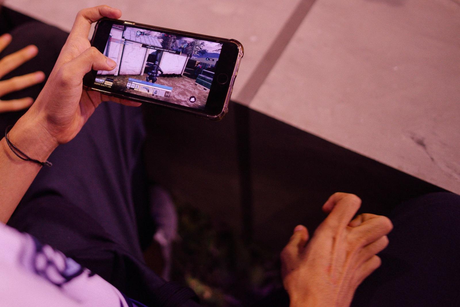 Virtual Insanity: Inside The Life of Pro-Gamers - Stretching fingers while gaming with smartphone