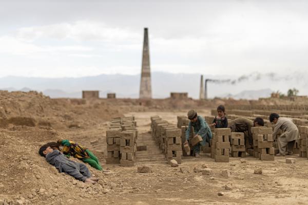 Contrasting Childhoods Joyful Play vs Hardship - Due to economic hardships, many children are forced to work alongside their parents in brick...