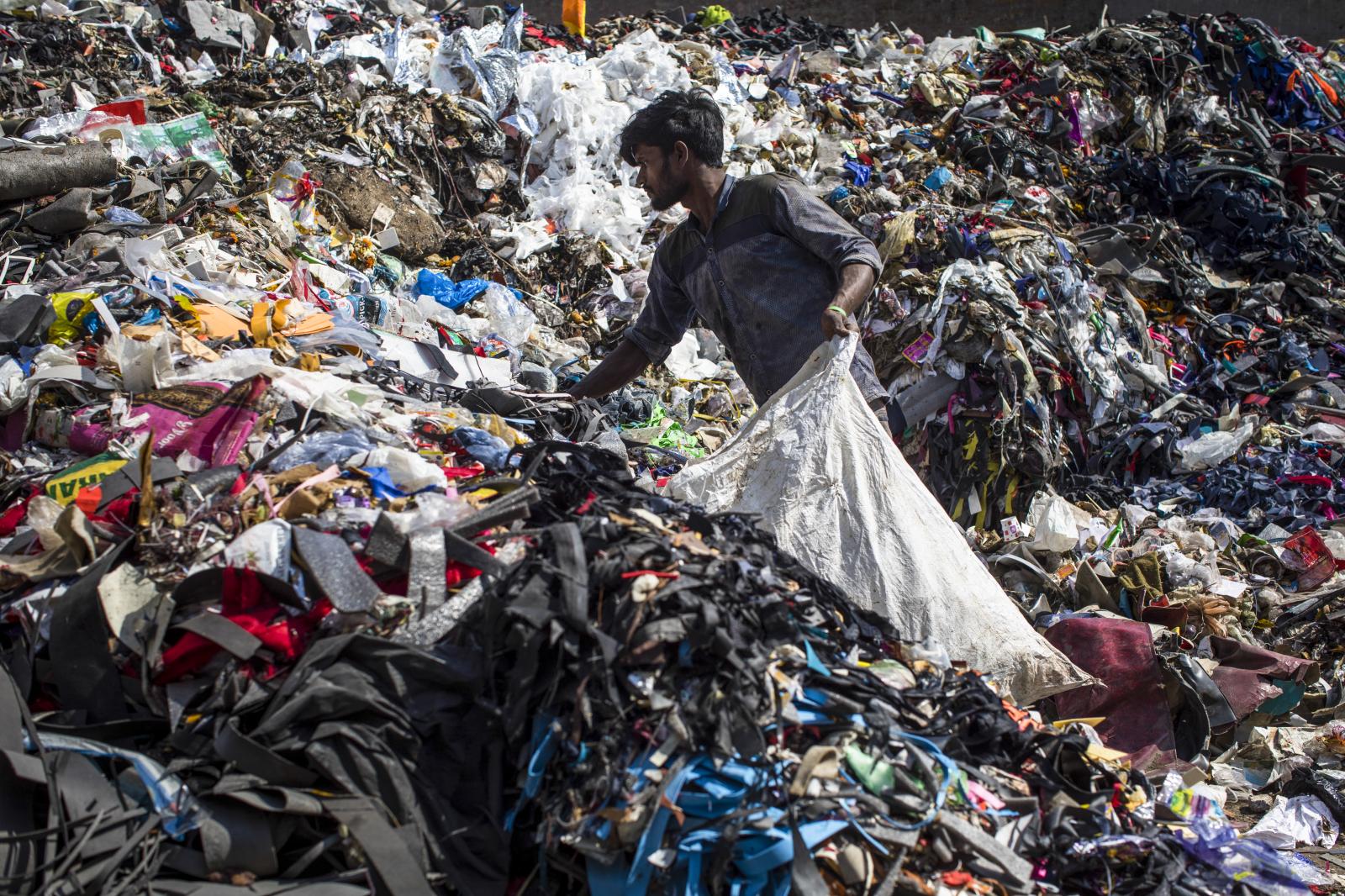 A ragpicker searches for recycl... of New Delhi on March 9, 2022.