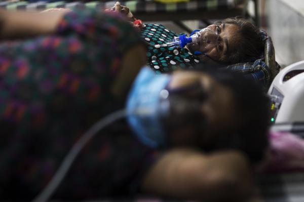 Image from India's Covid-19 pandemic - COVID-19 coronavirus victims breath with the help of...