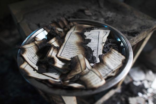 Image from News Coverage - A bowl filled with burnt-out copies of the Koran is found...