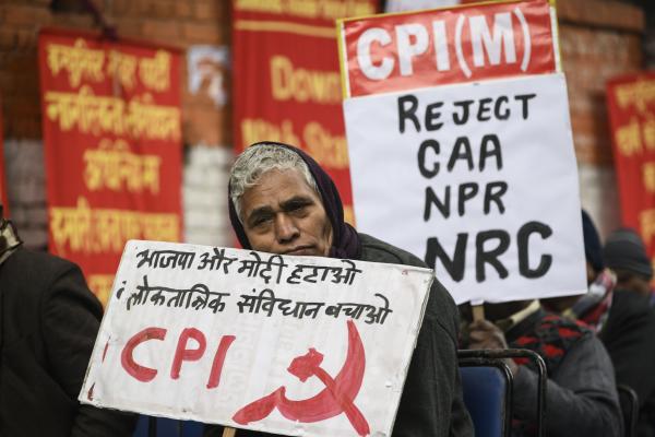 Image from News Coverage - An activist of the Communist Party of India (CPI) holds a...