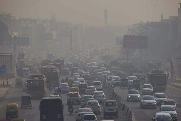 Image from News Coverage - Indian commuters drive amidst heavy smog along a busy...