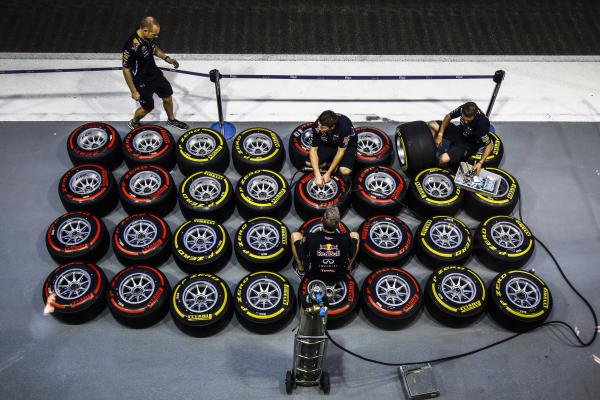 Image from Sports - Red Bull team members sort out tyres outside the...
