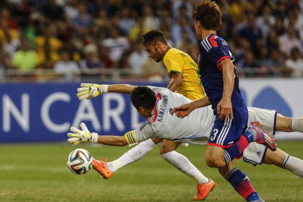 Sports - Brazil's Neymar shoots to score past Japan's...