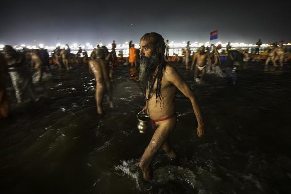 Image from Religion and Festivals - An Indian sadhu (Hindu holy man) wades at the Sangam --...