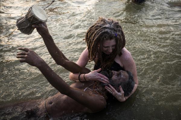 Image from Religion and Festivals - An Indian naked sadhu (Hindu holy man) bathes with the...