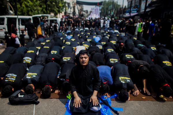 Image from Religion and Festivals - Shiite Muslim mourners pray during a procession on the...