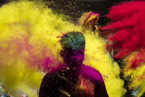 Image from Religion and Festivals - Youths throw coloured powder to their friend as they...
