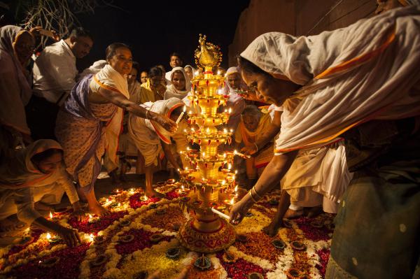 Image from Religion and Festivals - Indian widows light earthen lamps or 'diyas'...
