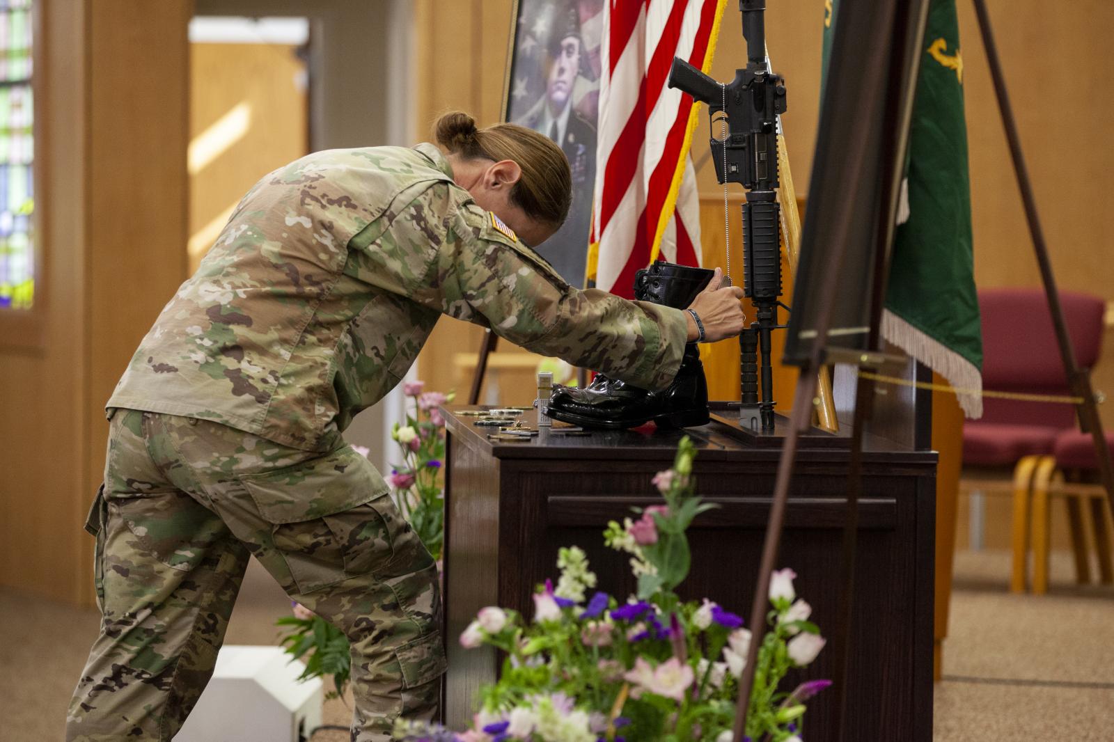 A U.S. Soldier grasps dog tags ...oto by Spc. Angel Ruszkiewicz) 