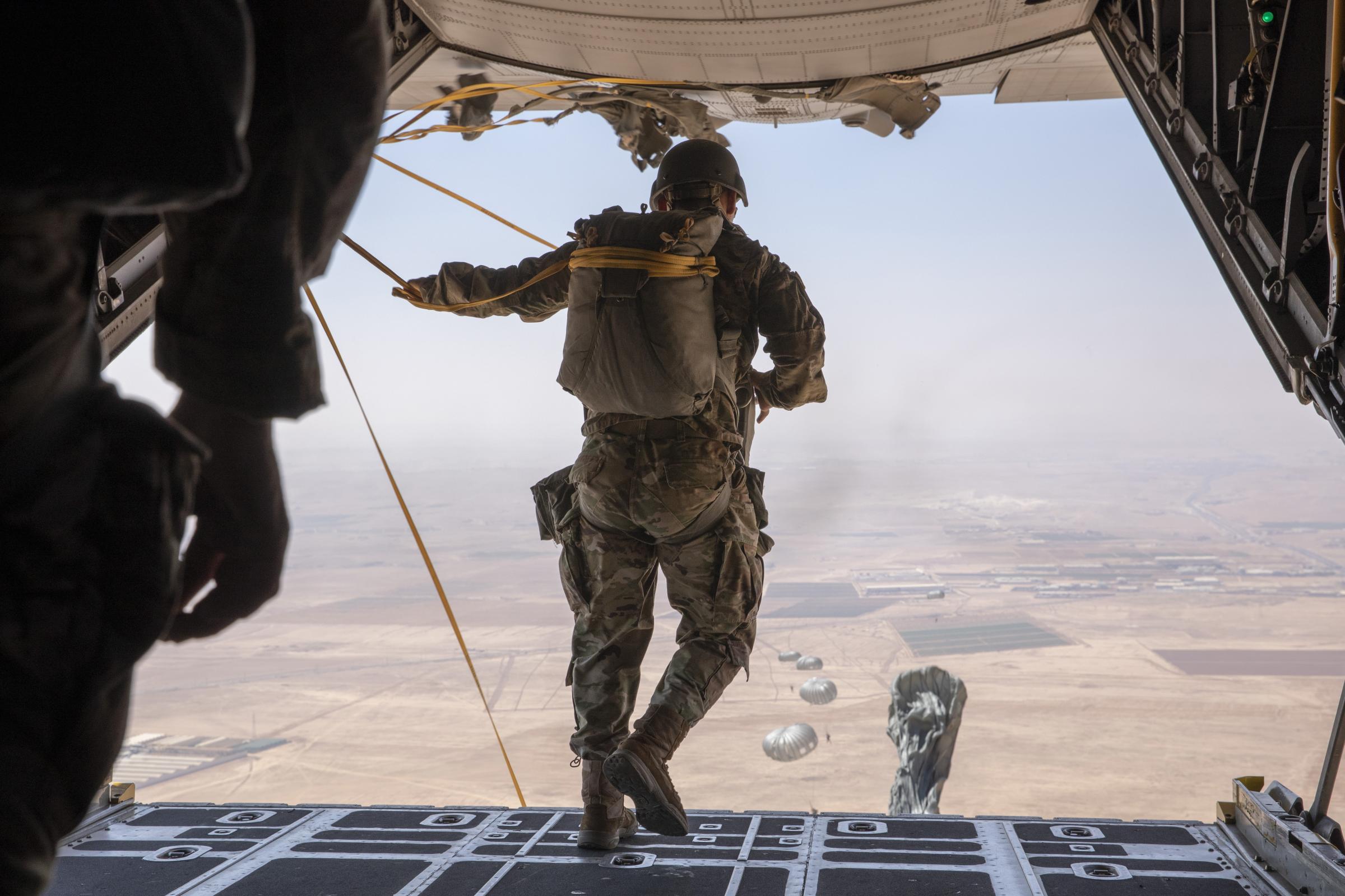 Military Photography - U.S. Special Operations Forces jump from a C-130 Hercules...