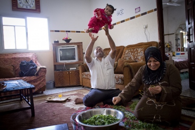  Nasser Abu Emeira at home with his wife and grand daughter preparing dinner in Beach Camp, Gaza City, Gaza Strip. 