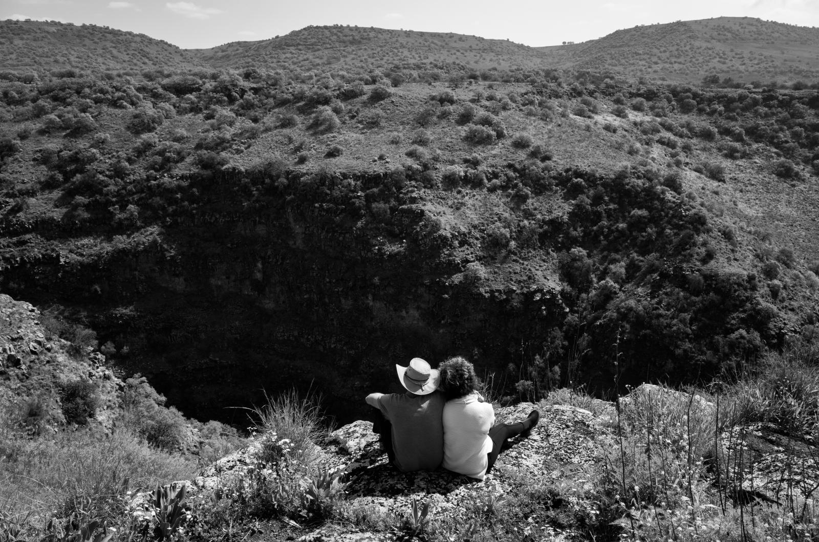 Couple relaxing in mountains.