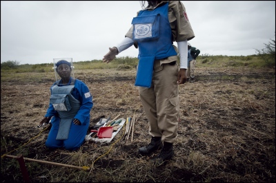  HALO Supervisor Arcillia Adriano discusses the approach they should take at Damo minefield with deminer Matilde Fatima. Maputo Province, Mozambique. 