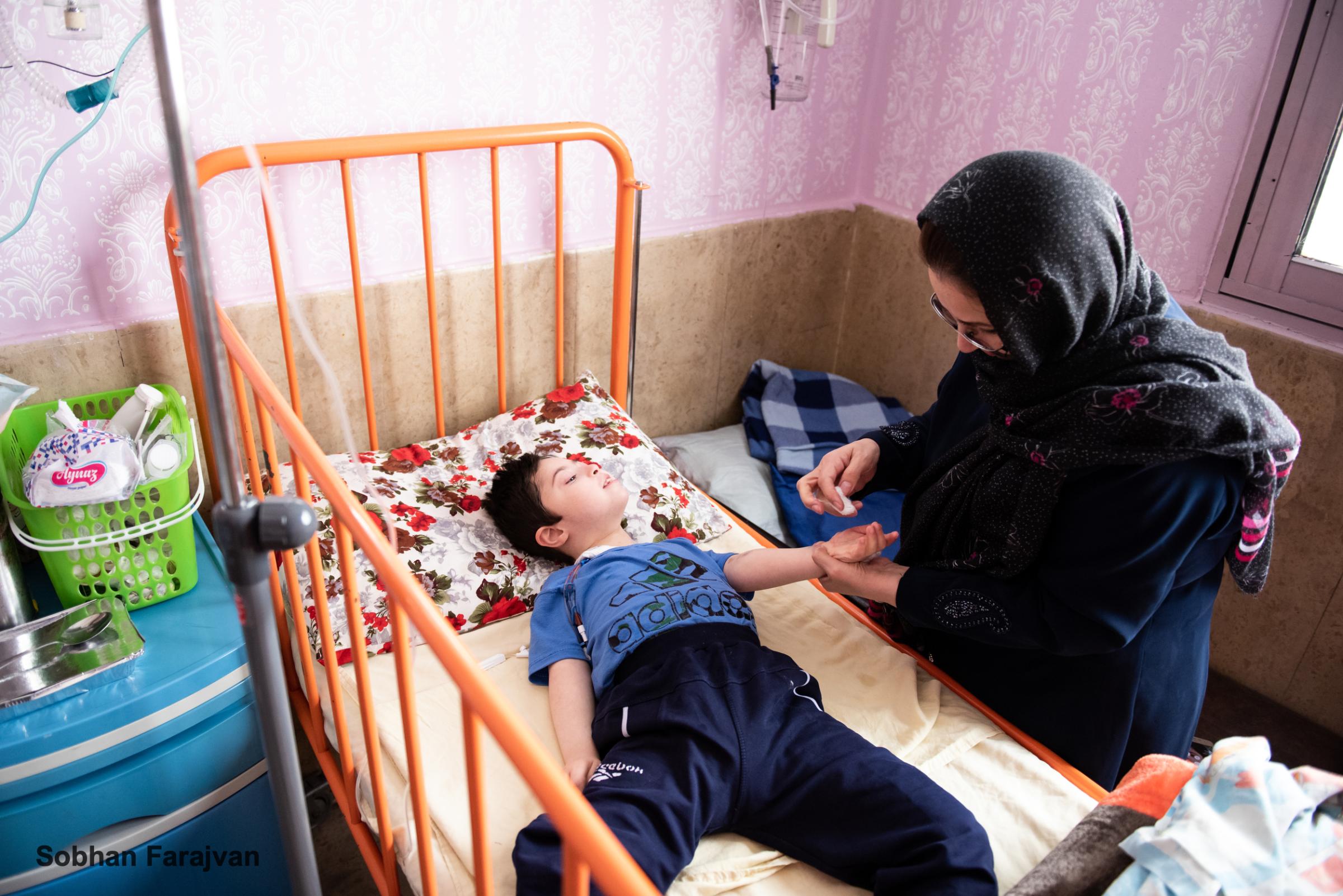 COVID-19 pandemic in Iran (2020-2022) - An Iranian mother takes care of her 9-year-old autistic...