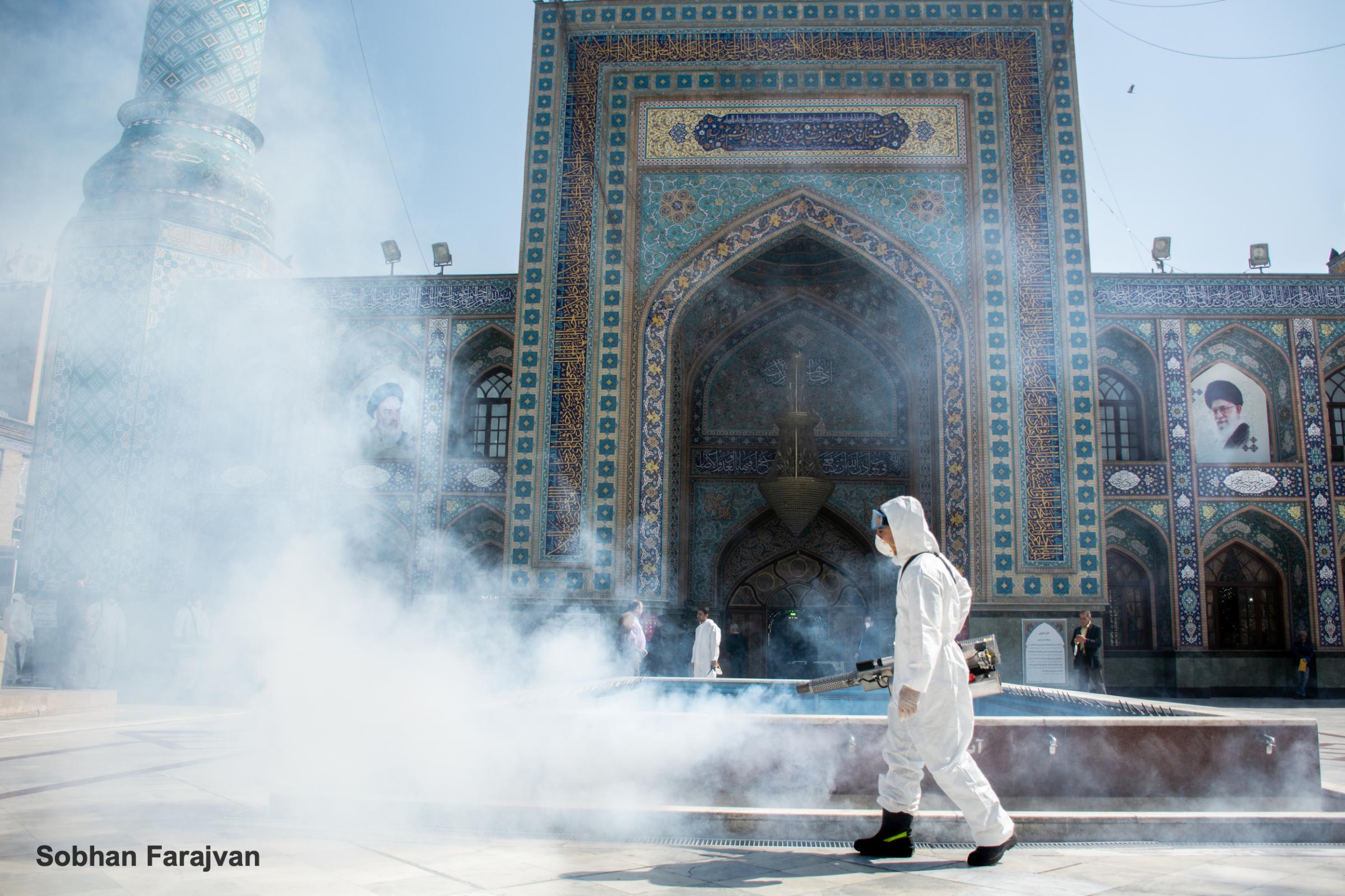COVID-19 pandemic in Iran (2020-2022) - An Iranian fire department staff disinfect a religious...
