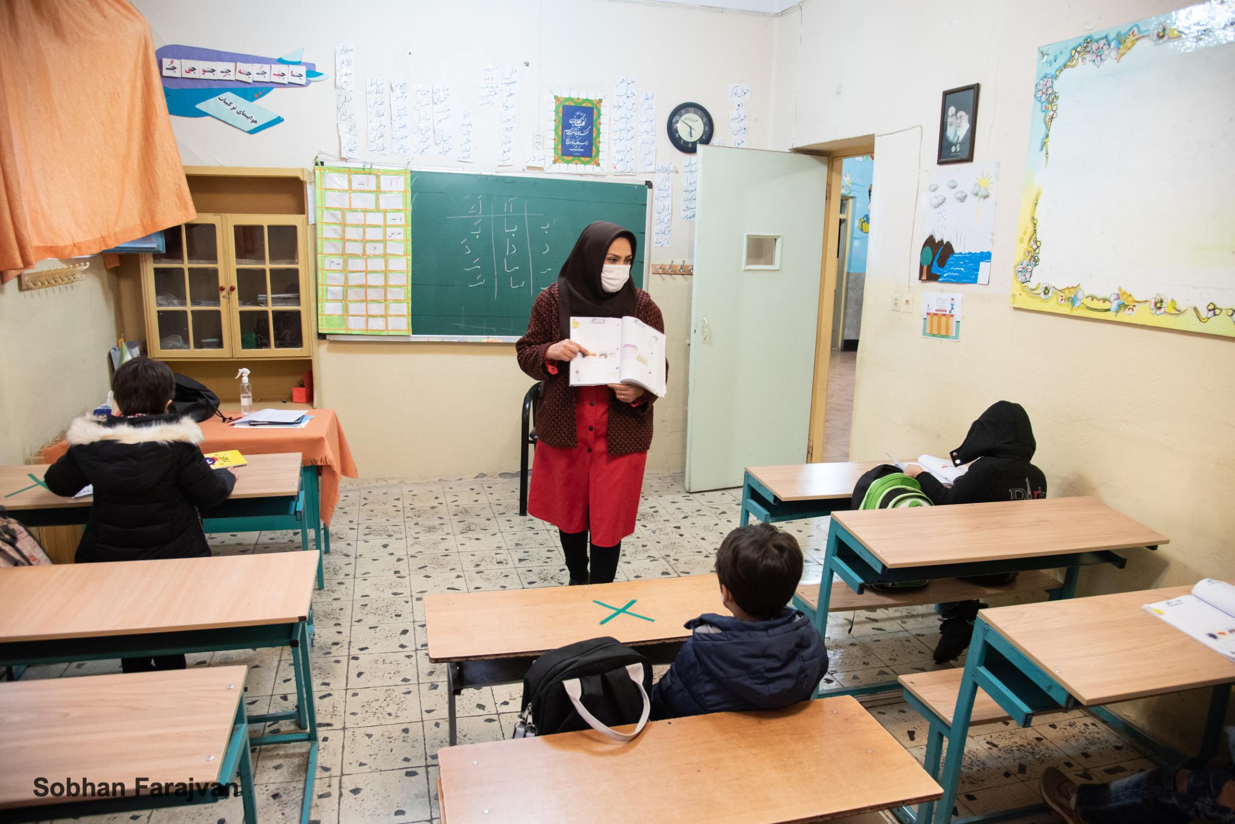 COVID-19 pandemic in Iran (2020-2022) - students wearing mask as a precaution amid the spread of...