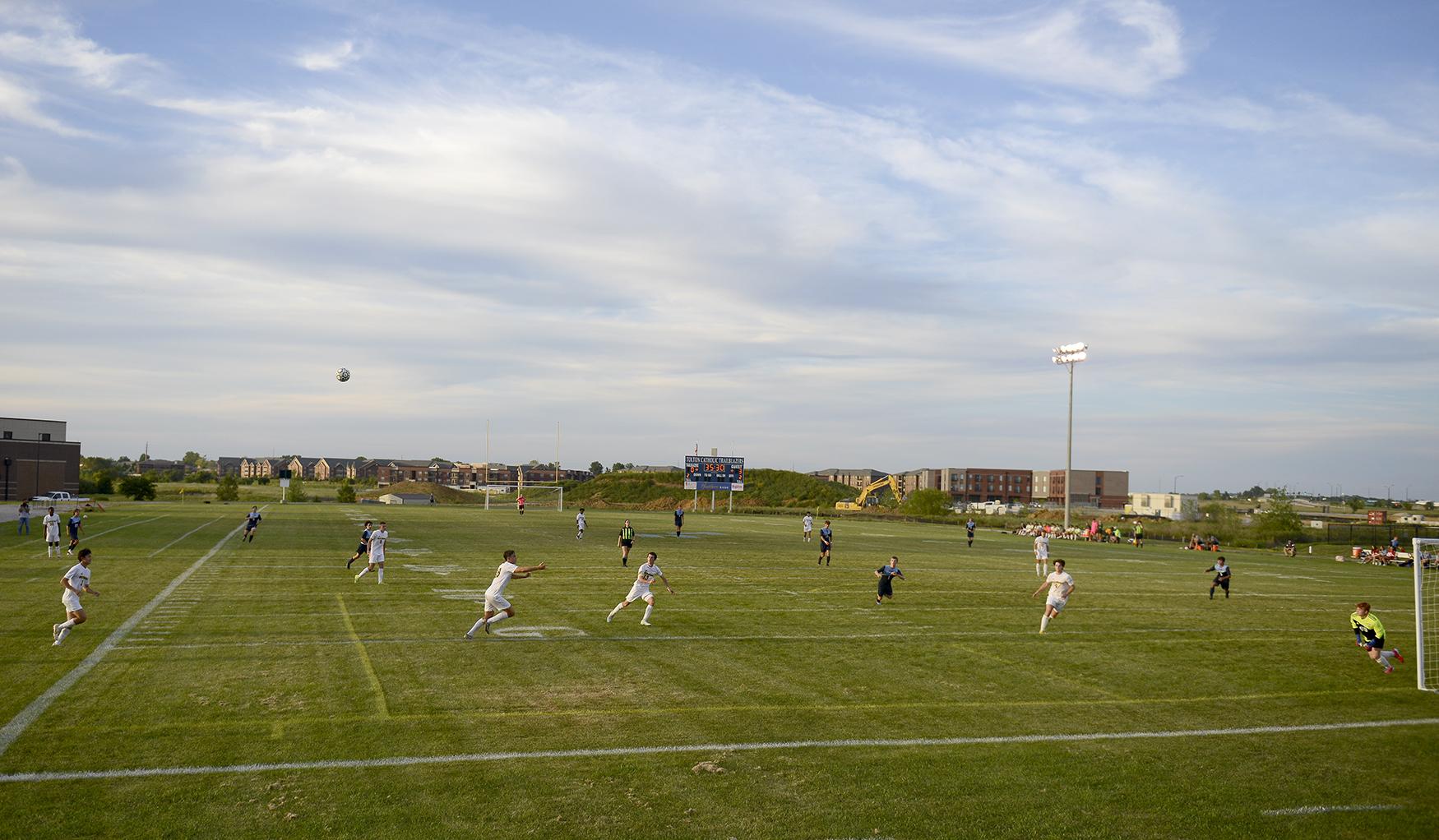 Sports - Players watch the ball fly toward the Rock Bridge net on...