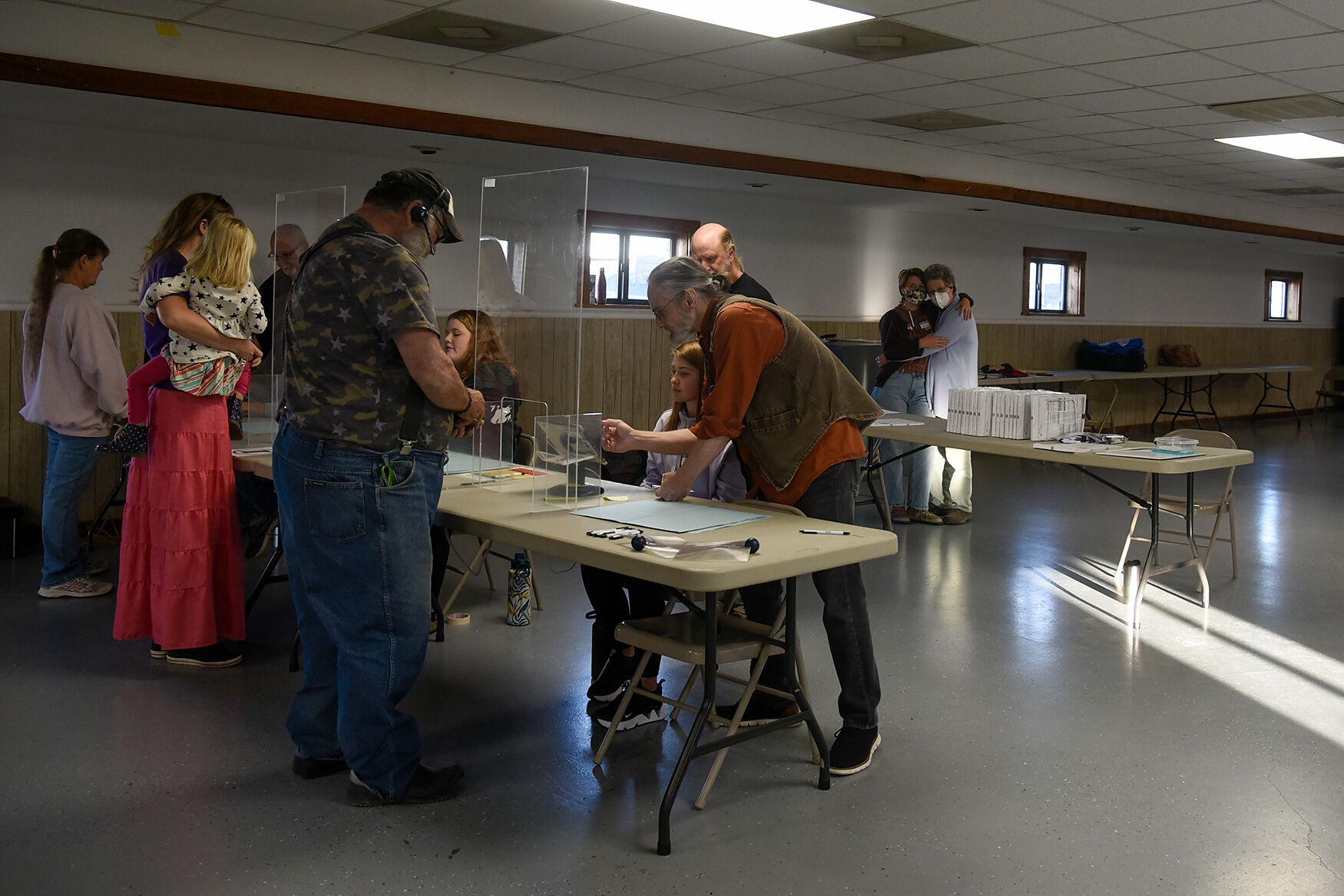 Election Day at the edge of the county - Poll workers check in voters Tuesday, Nov. 8, 2022, in...