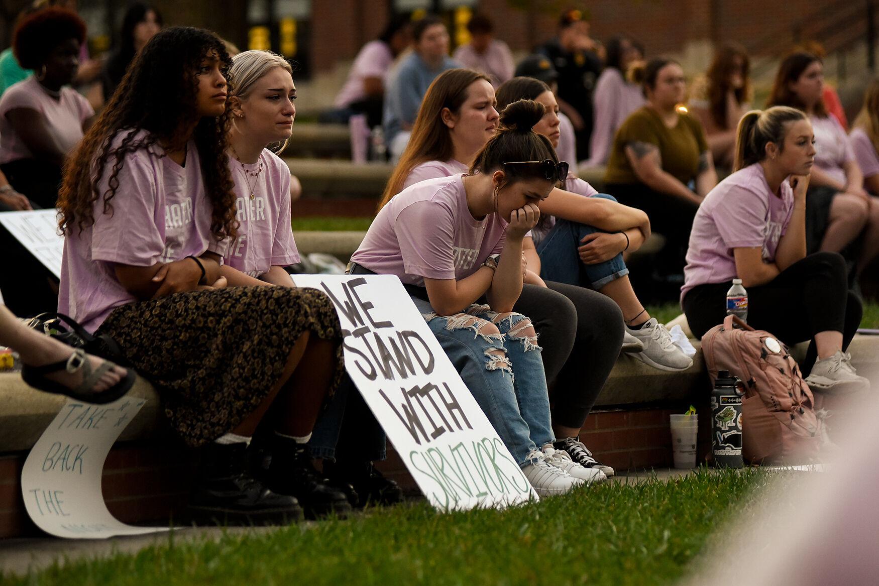 News & Feature - Ellie Witzman, center, cries in reaction to a...