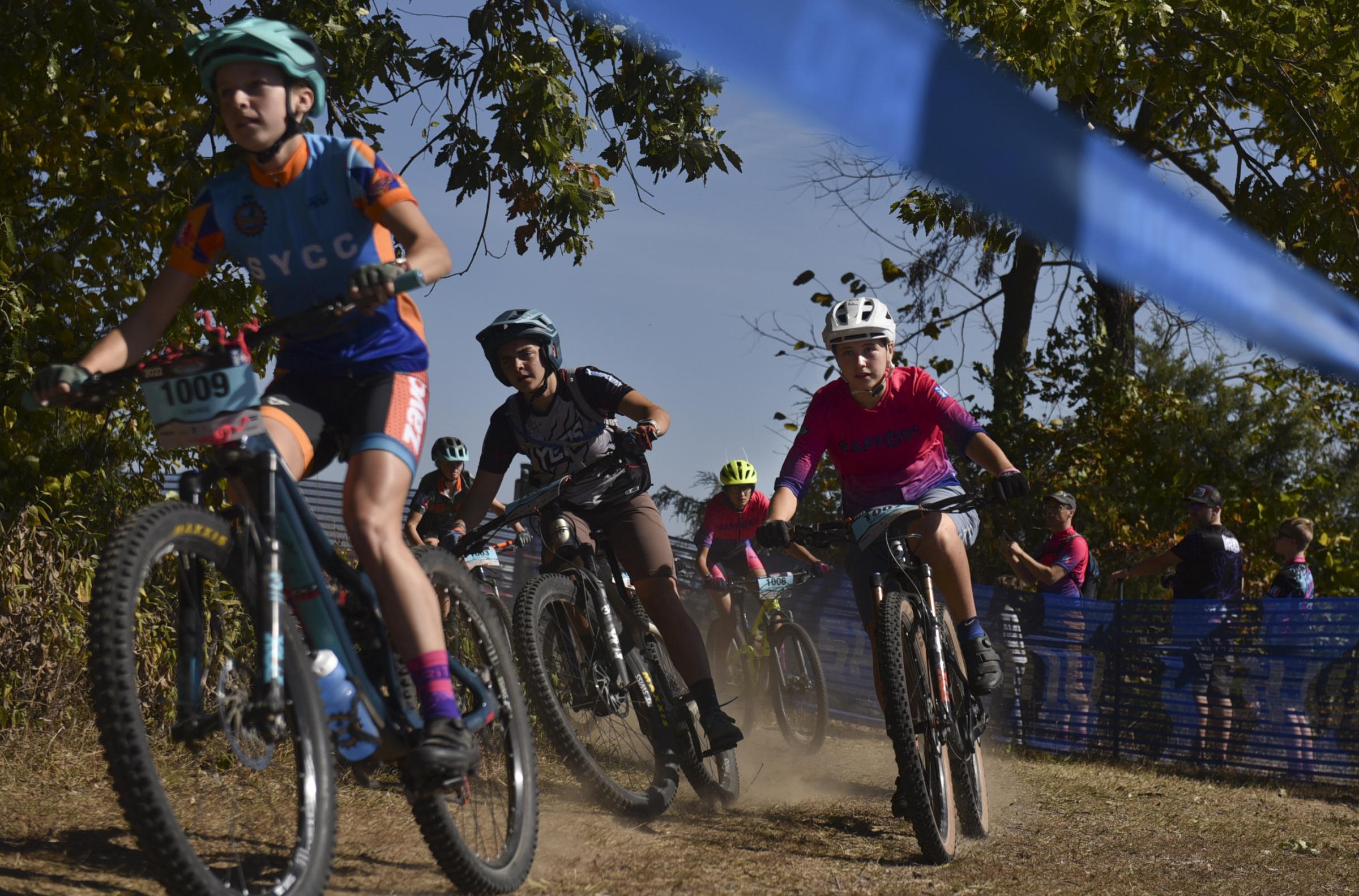 Community, competition and mountain biking - Marlowe Weis, right, takes a turn in the first couple...