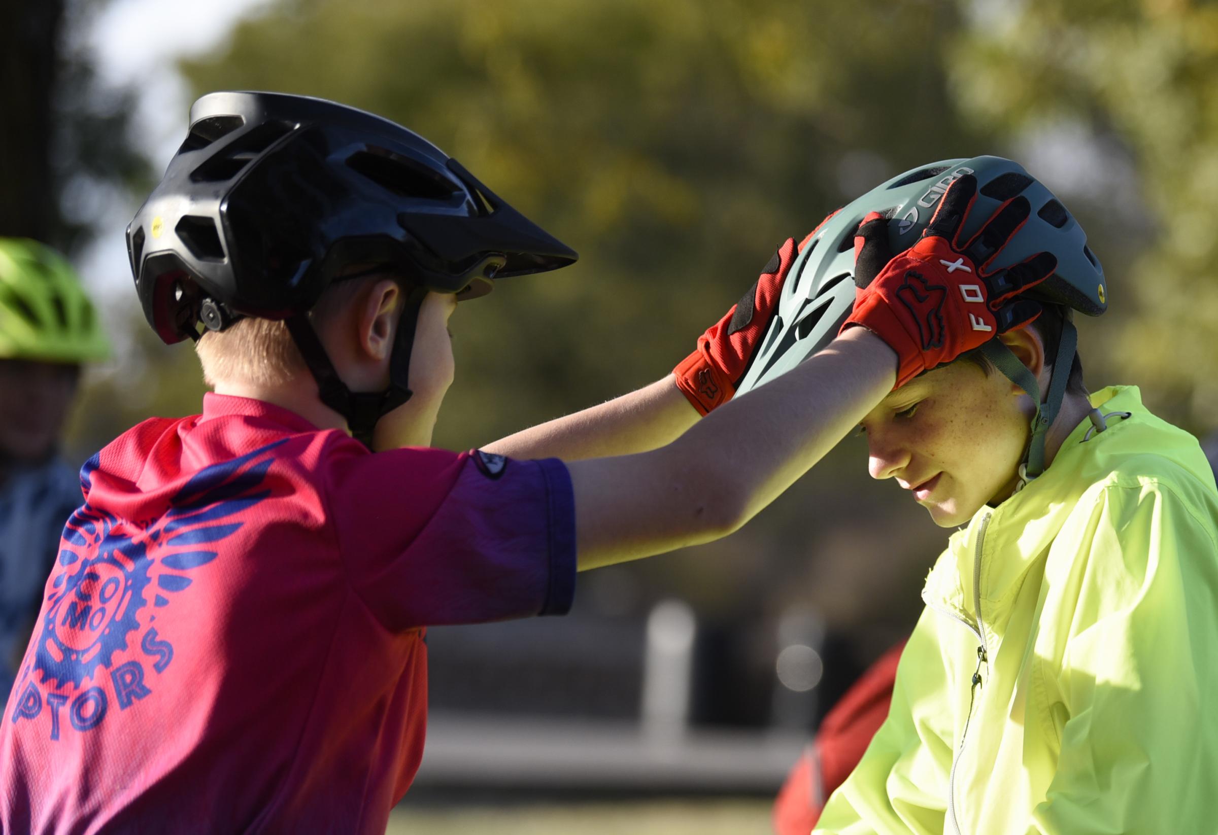 Community, competition and mountain biking - John Huffington adjusts Kaid Shaw’s helmet before...