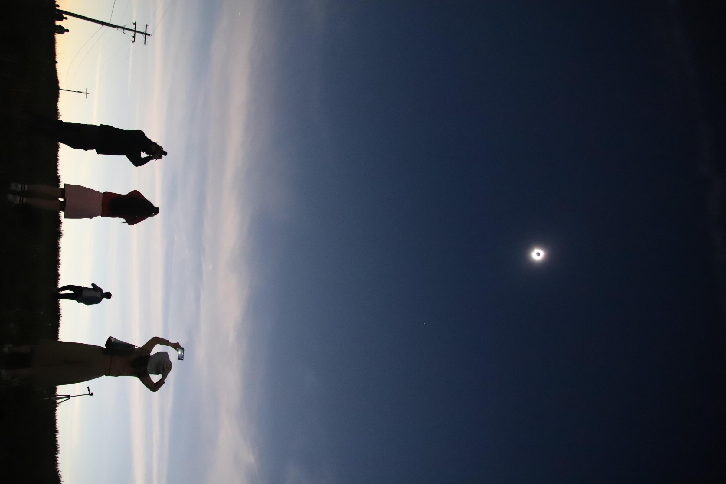 Singles -  The solar eclipse reaches totality in Jackson, Mo. Off...