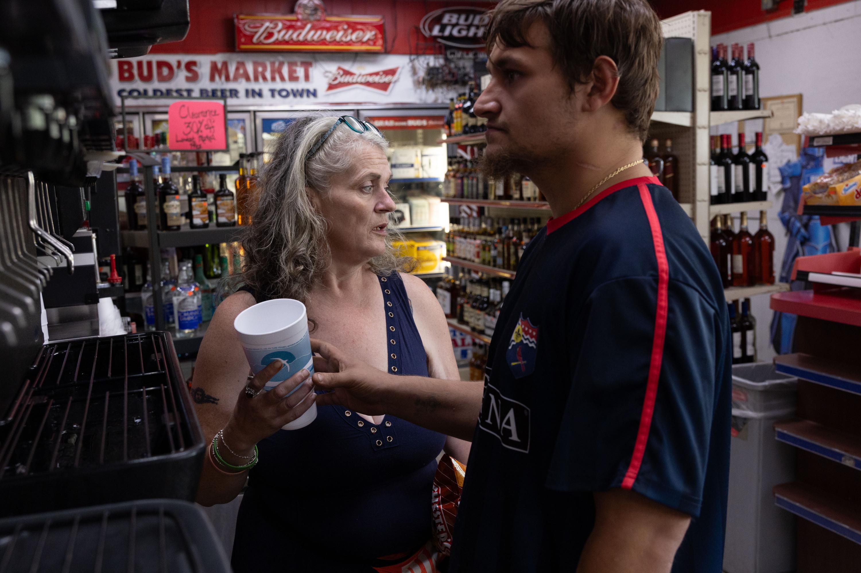 Carrie, Keeper of the House - Carrie Kuhl passes Austin Bledsoe a soda cup while...