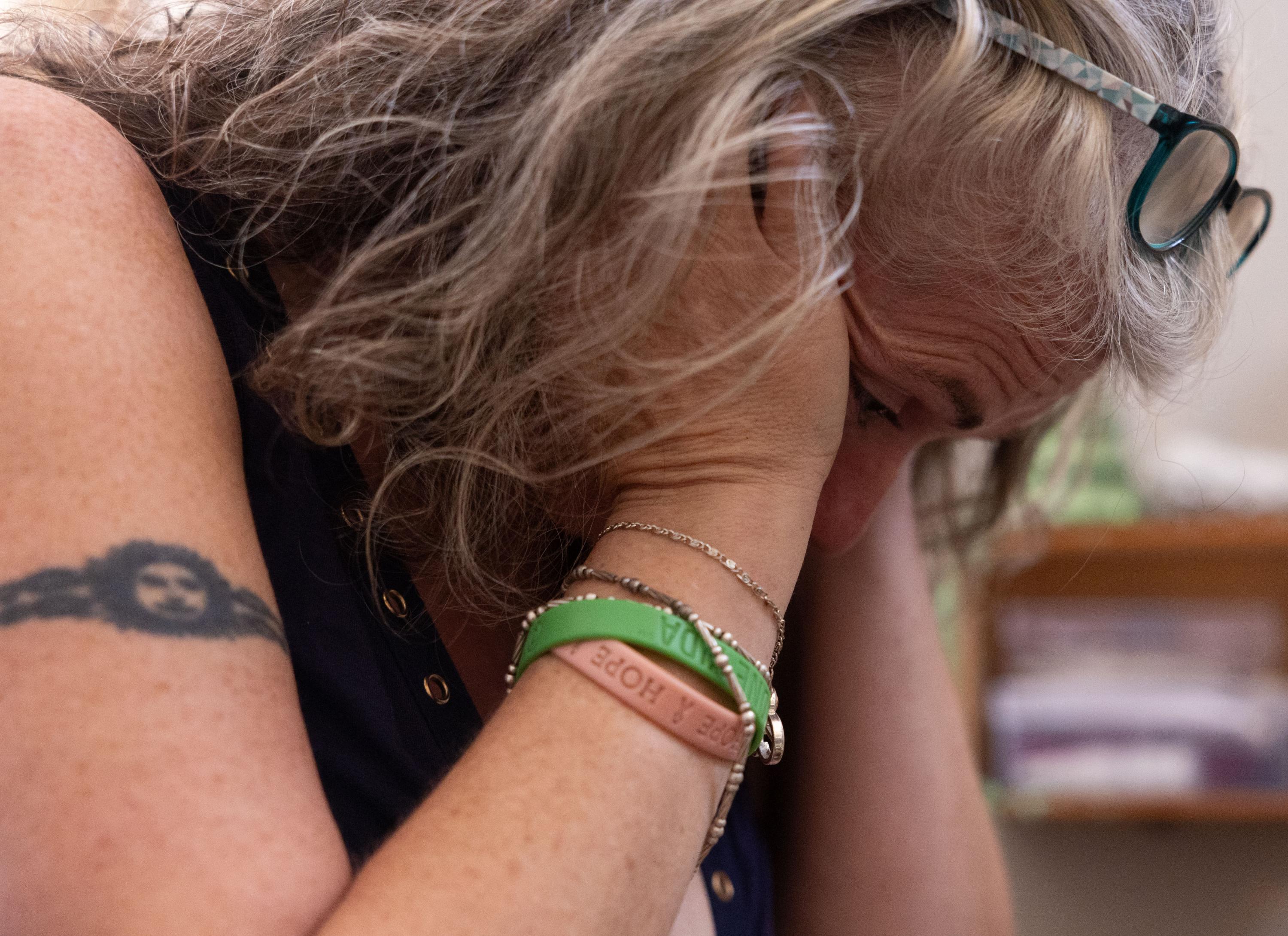 Carrie, Keeper of the House - Carrie Kuhl rests with her head in her hands. Kuhl had a...