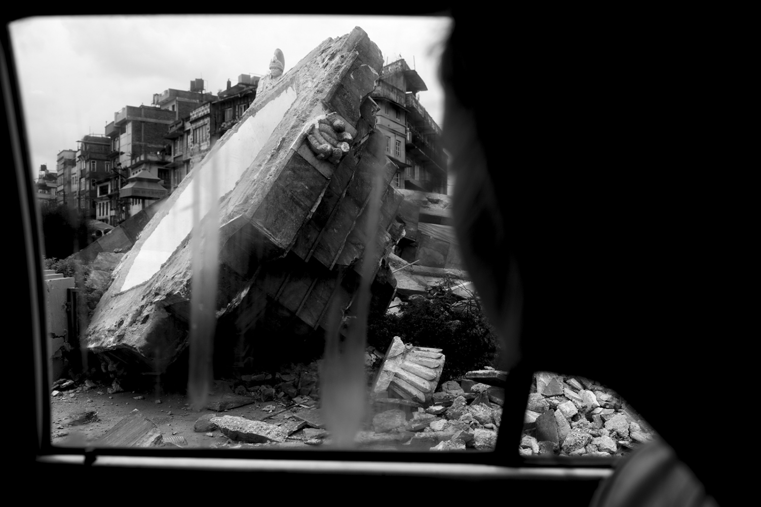  Destructions were visible everywhere in Kathmandu. On image a tourist taking a taxi past a roundabout.Â 