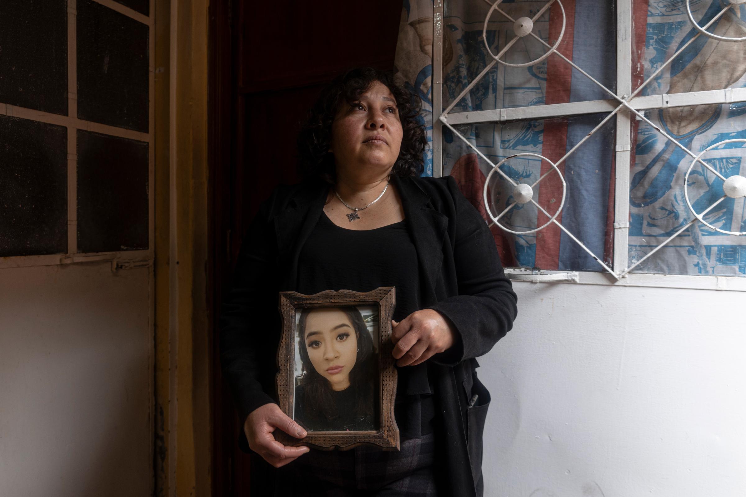 The belongings of Andrea Salgado, victim of femicide -  Angelica with a picture of her daughter, Edomex, 2022. 