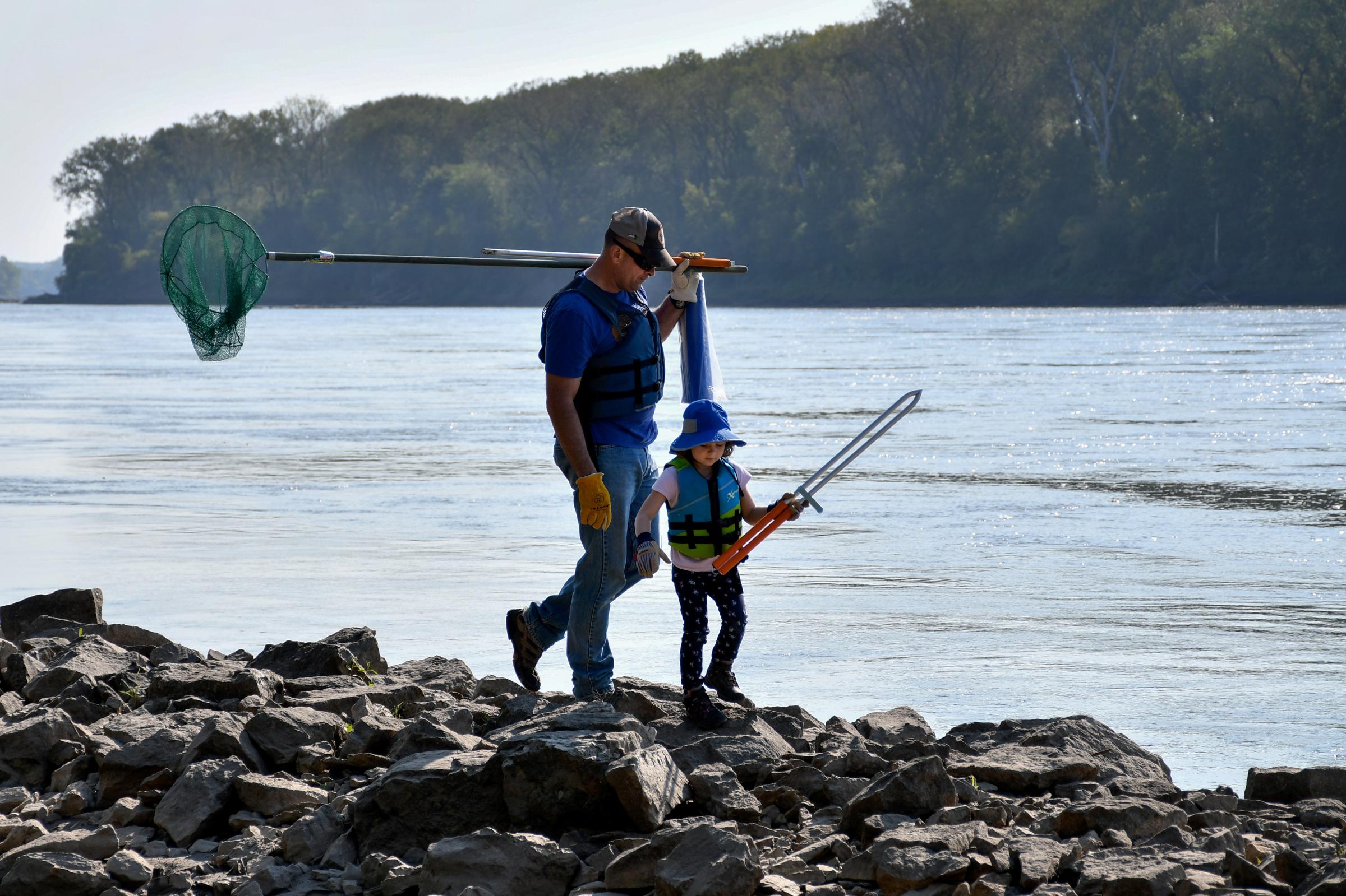 River Relief - Zach Davenport and Phoebe, 4, make their way to the river...