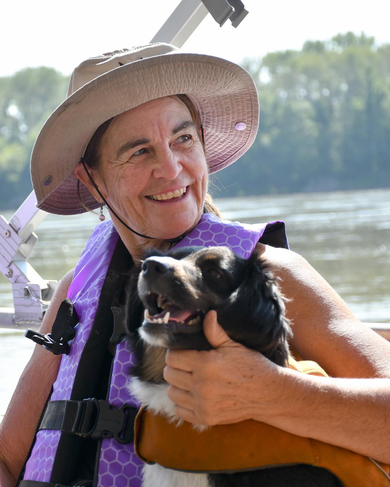 River Relief - Nancy McKenna holds Banjo the dog on the boat ride back...
