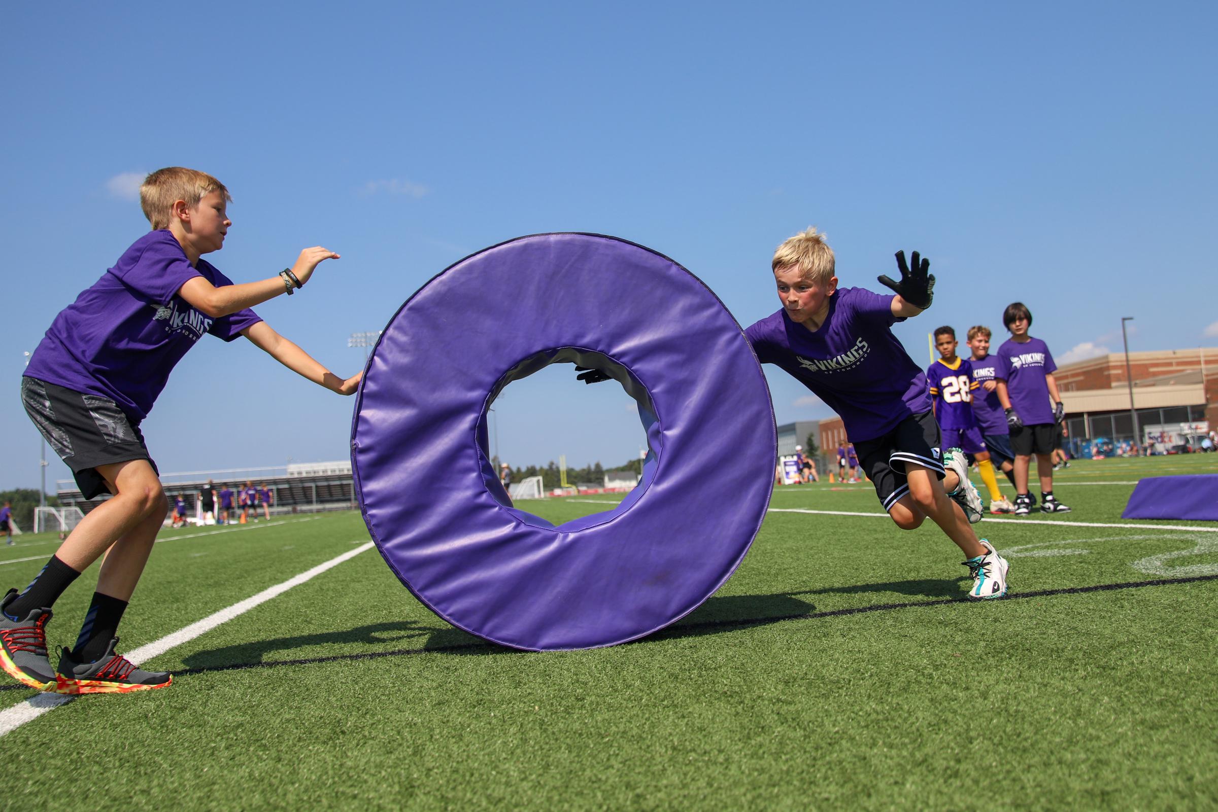 An image from July 12, 2024 of a youth football camp at Stillwater Area High School in Stillwater, MN. Youth Football Camp