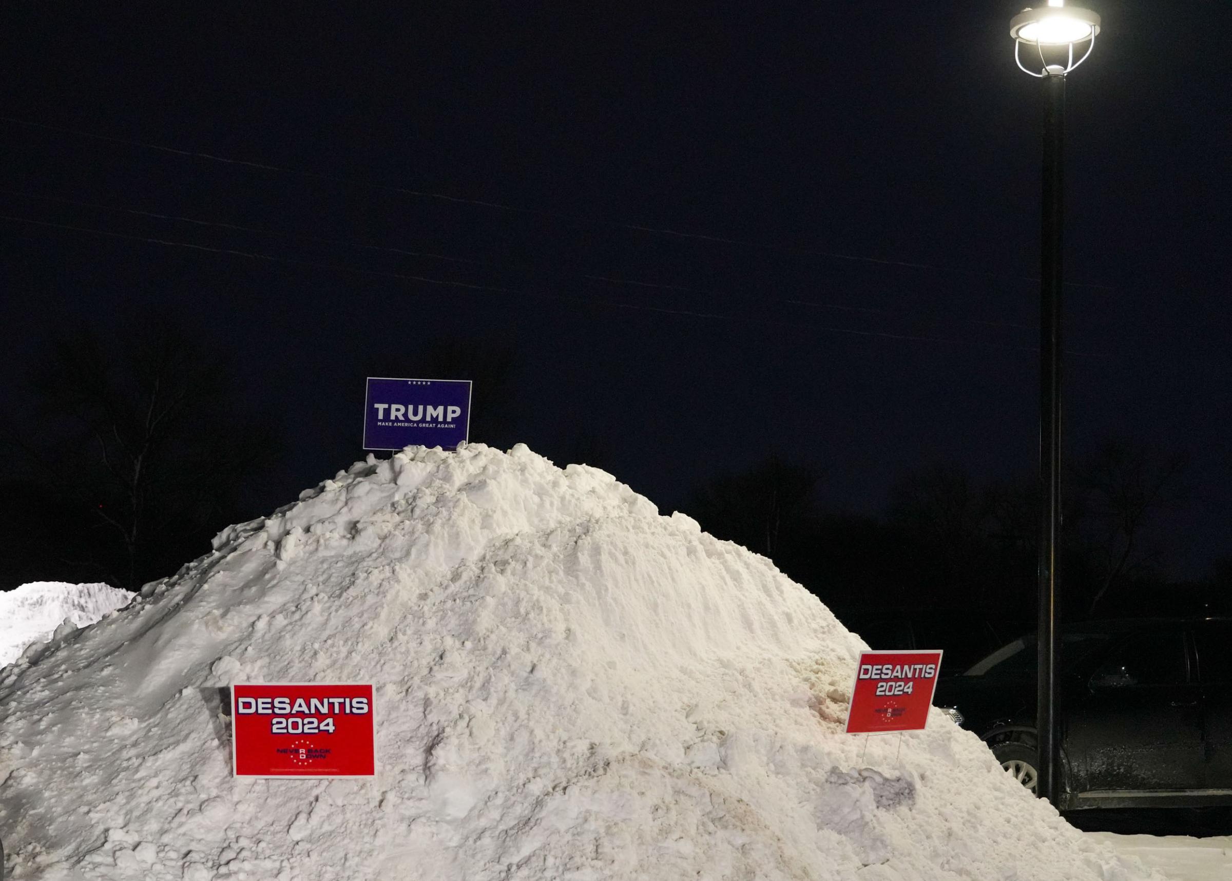 2024 Iowa Caucus  - Campaign signs stick out of the snow on Monday, Jan. 15, 2024, at Horizon Events Center in Clive,...