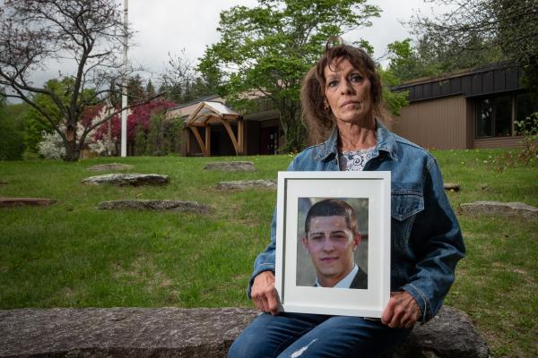 Image from Portraits - Cheryl Rusin holding a photograph of her son Connor, who...