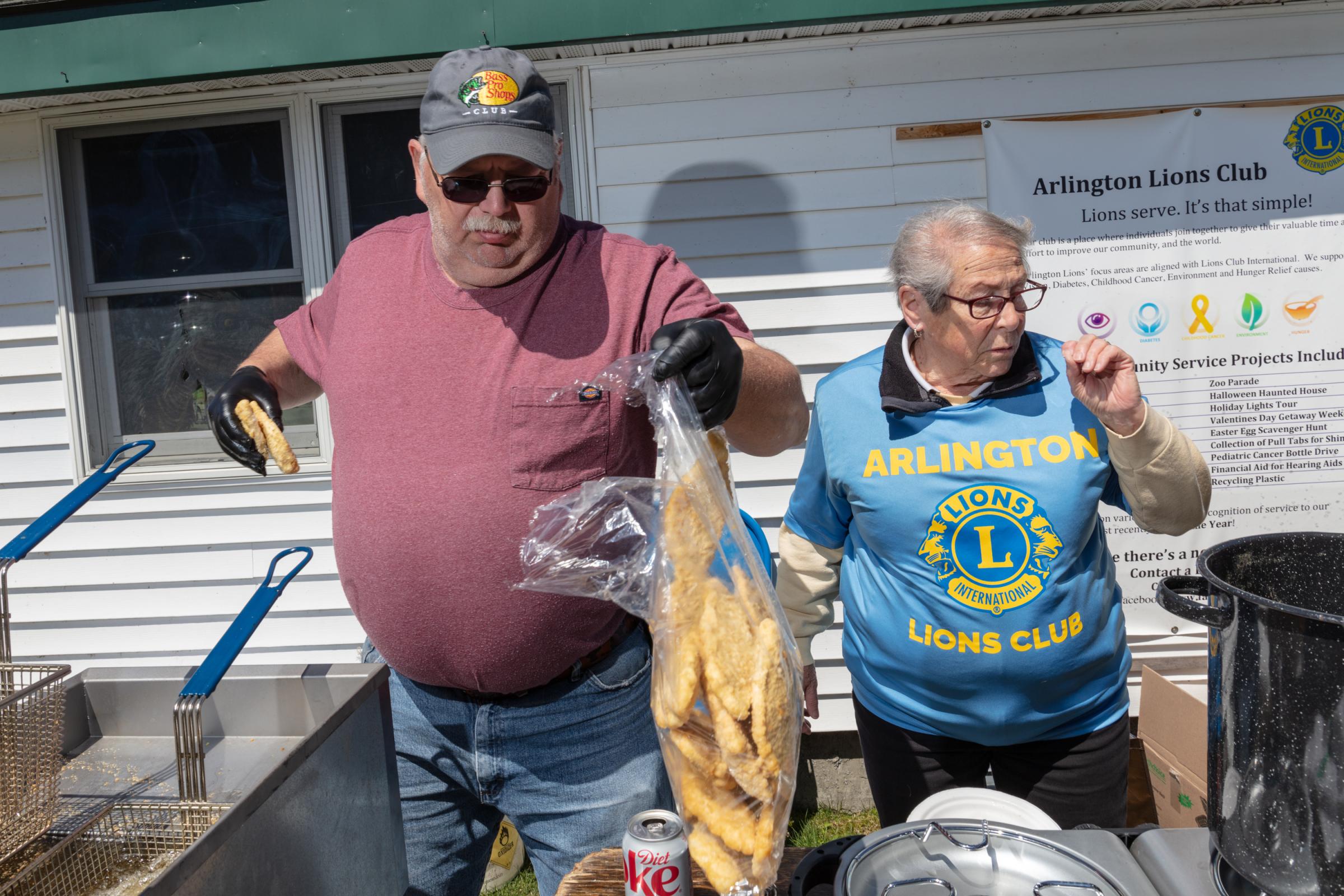 Singles - Mike and Dale Wood of the Arlington Lions Club prepare...