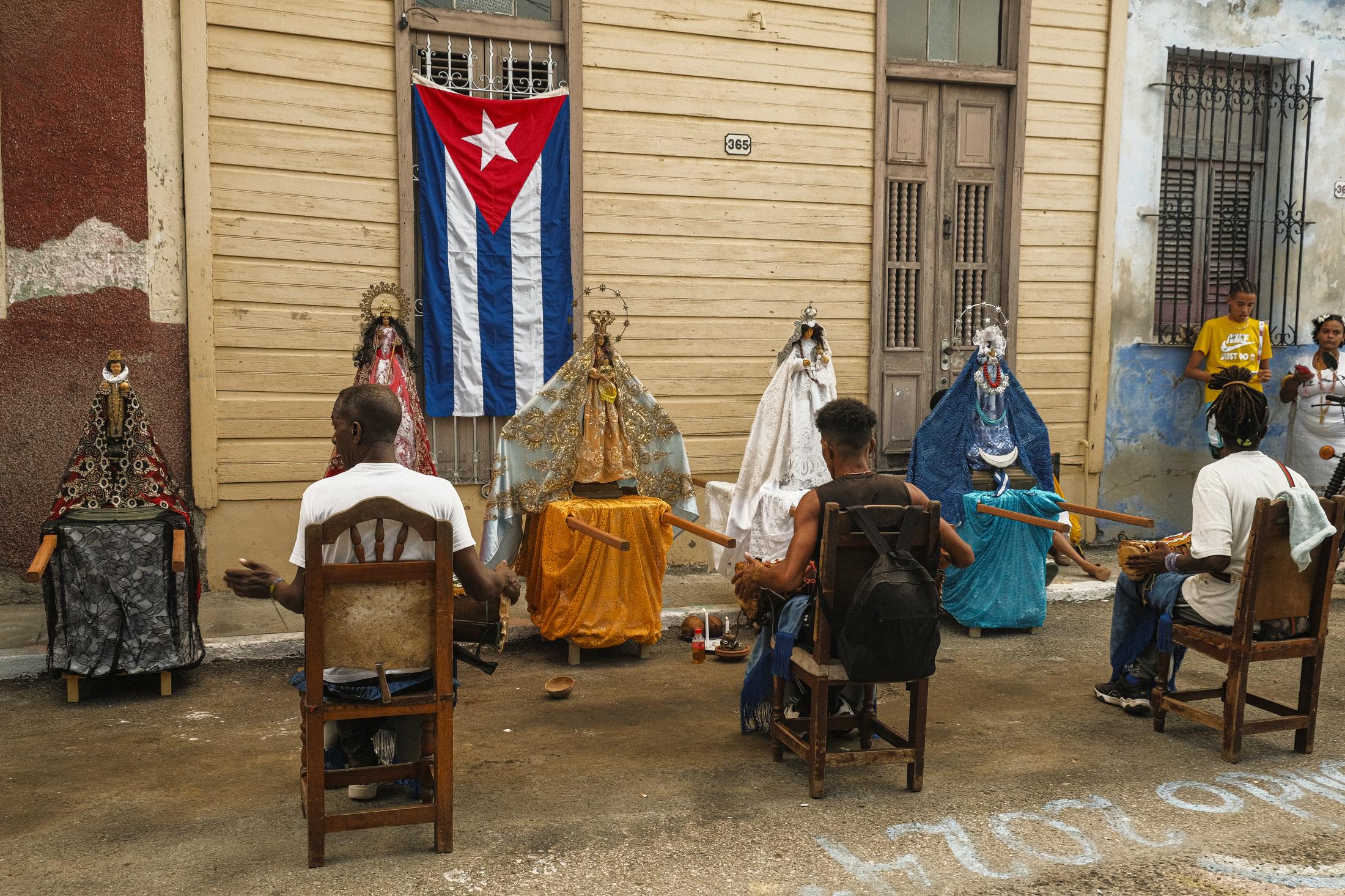 Bataleros play batá drums during the celebation of Cabildo of Yemaya in the town of Regla.